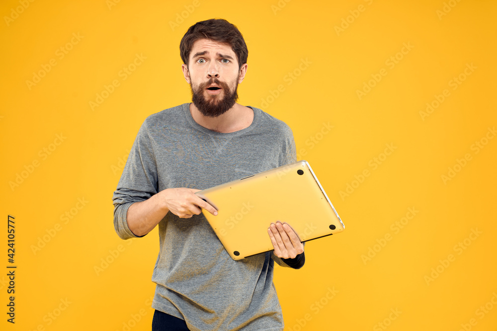Man with a tablet in the hands of technology communication professional yellow background Man with a tablet in the hands of technology communication professional yellow background