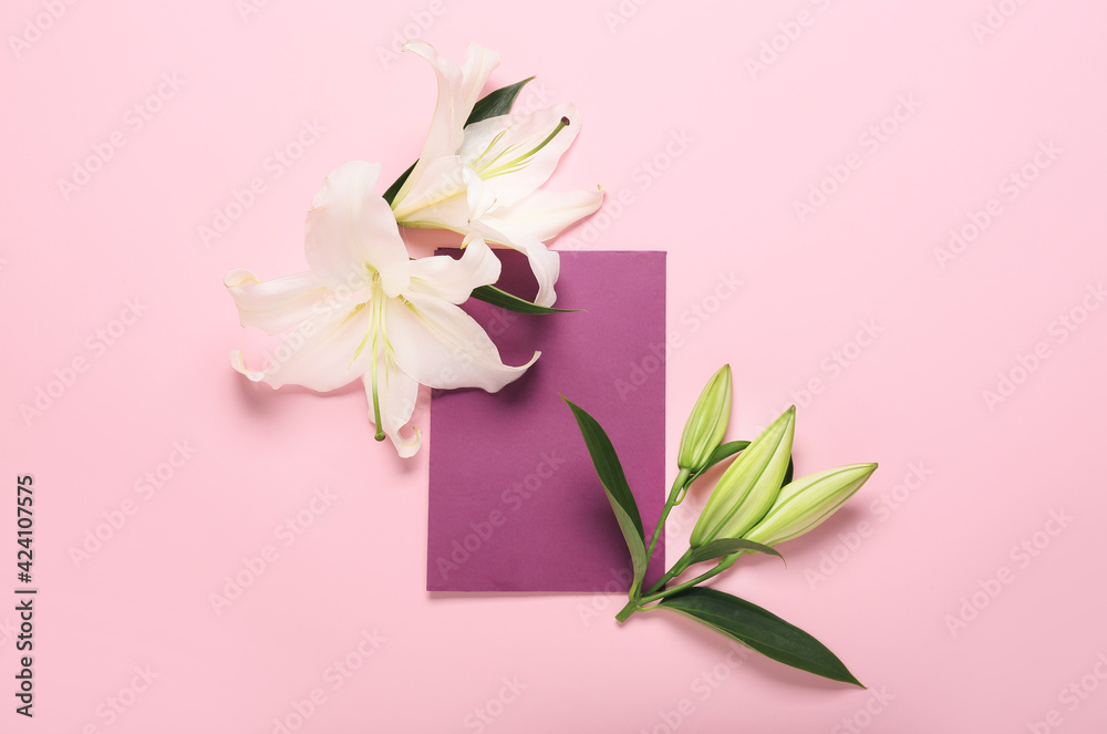 Beautiful lily flowers and blank card on color background