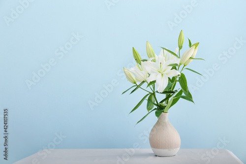 Wallpaper Mural Vase with beautiful lily flowers on table against color background Torontodigital.ca