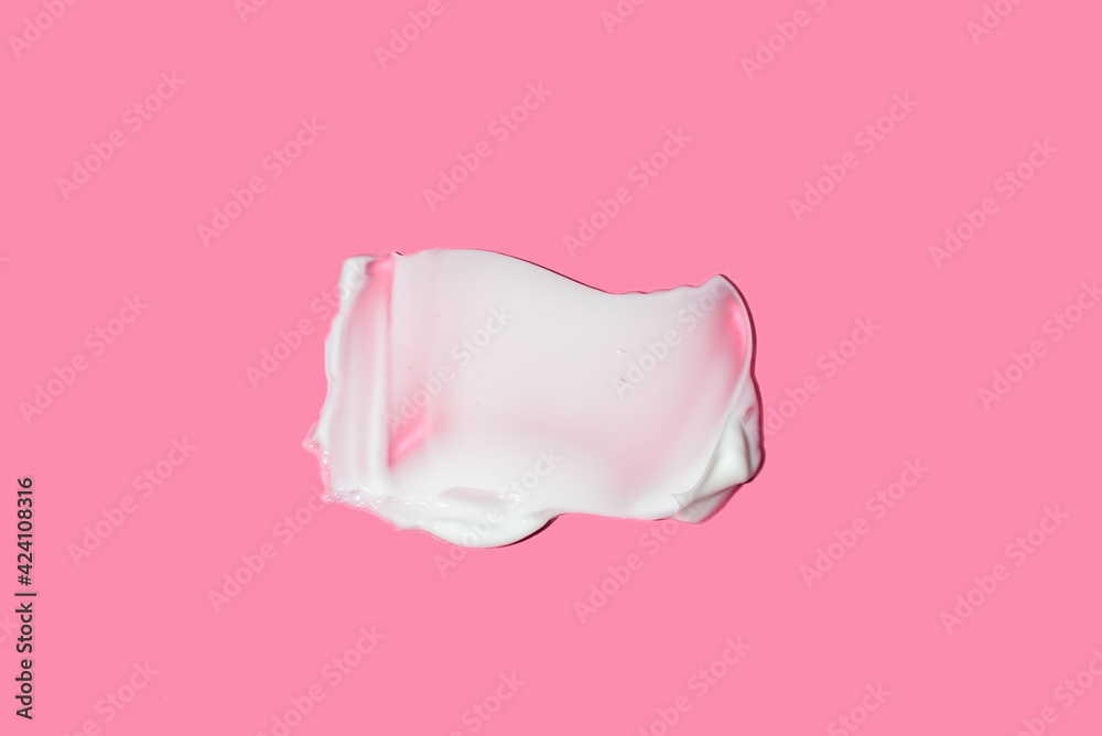 Swatch of moisturising body cream on pink background