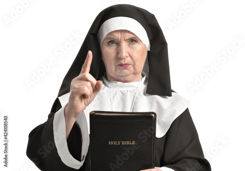 Severe senior nun with Bibl...