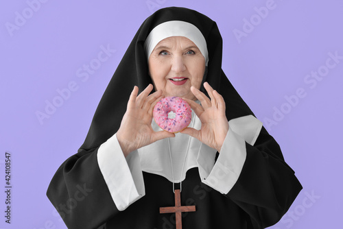 Senior nun with donut on co...