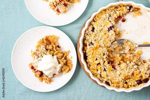 Two plate with apple and pear crumble, gluten free healthy streusel with oats, nuts. Sweet dessert with stewed fruit topped crisp crumbly mixture served ice cream. Apple cobbler diet pie, top view