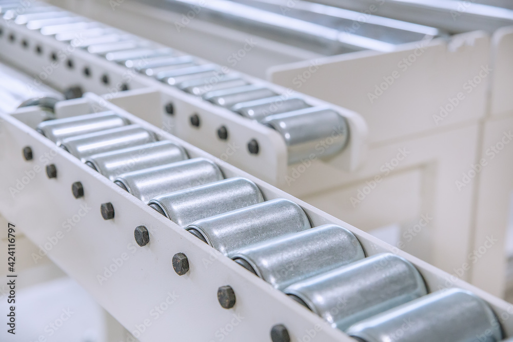 Metal construction, rollers. production conveyor. Selective focusing on rollers. A photo with a shallow depth of field. Metal construction, rollers. production conveyor. Selective focusing on rollers. A photo with a shallow depth of field.