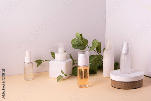 Cosmetic containers and skin care products on light background