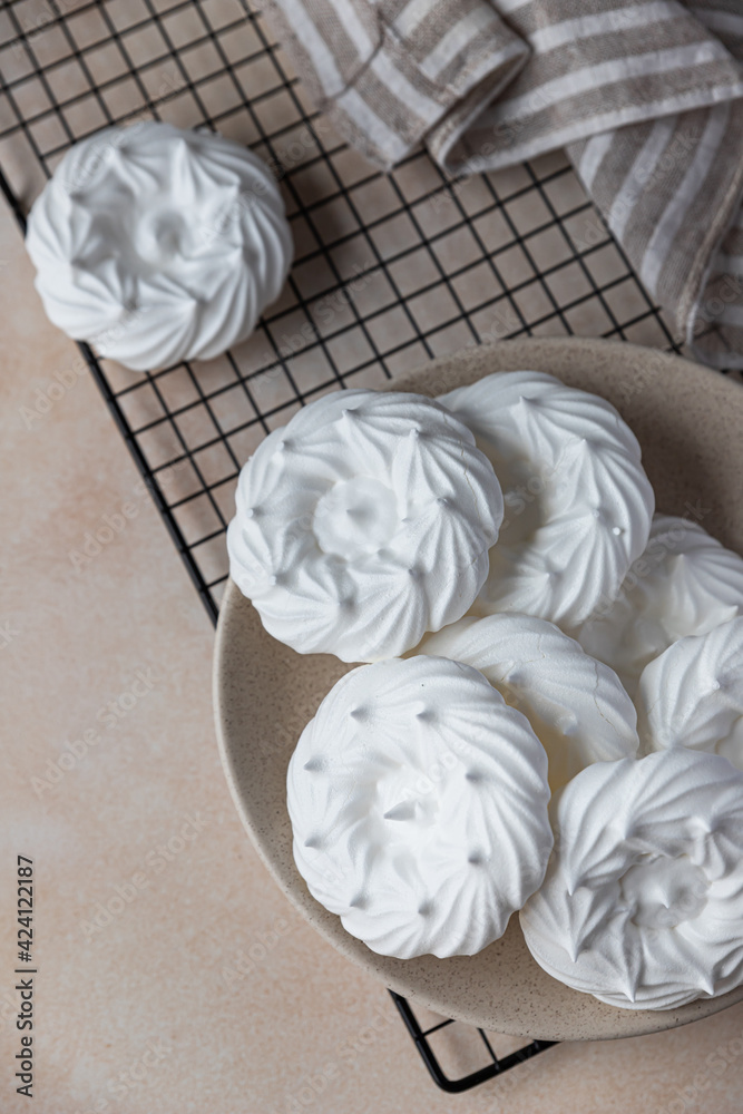 Empty meringue nests, light stone background. Concept for a tasty sweet dessert. Top view. Empty meringue nests, light stone background. Concept for a tasty sweet dessert. Top view.