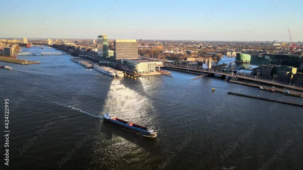 Amsterdam center, the Ij river at the central train station ships passing by Amsterdam center, the Ij river at the central train station ships passing by