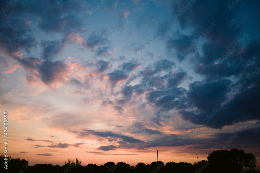 Fototapeta premium beautiful bright sunset, expressive blue-orange sky. Evening time