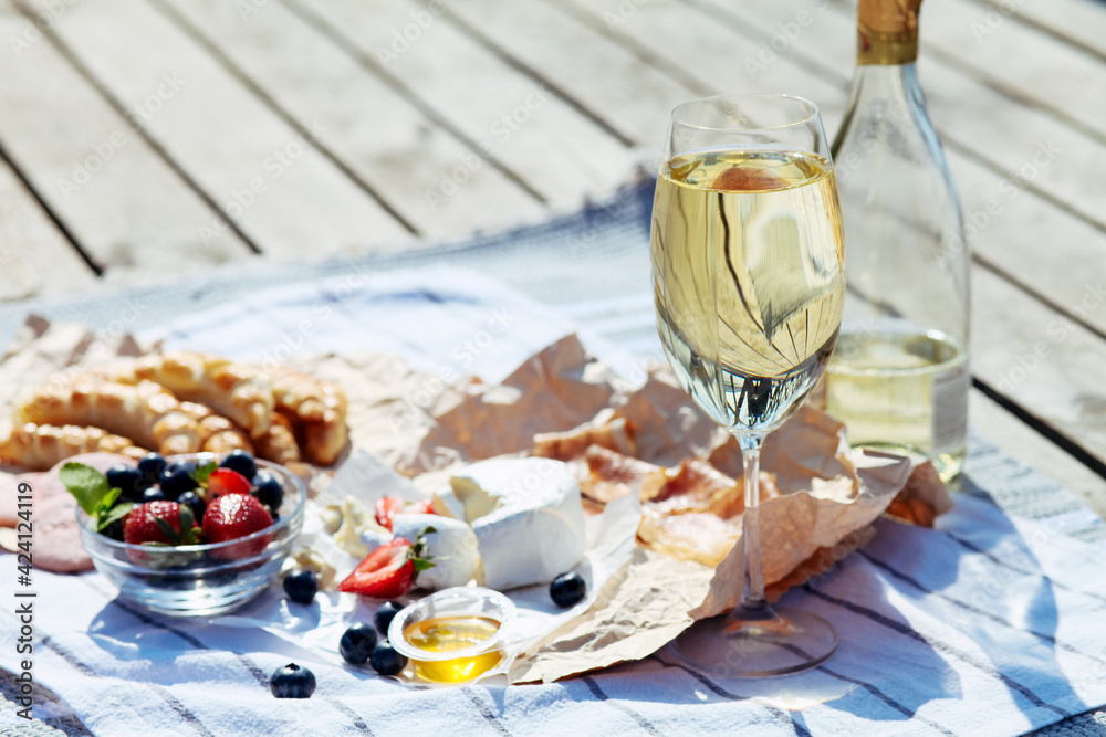 Сhilled white wine in a glass. cozy evening on the terrace. Summertime relax on the sunny patio. 