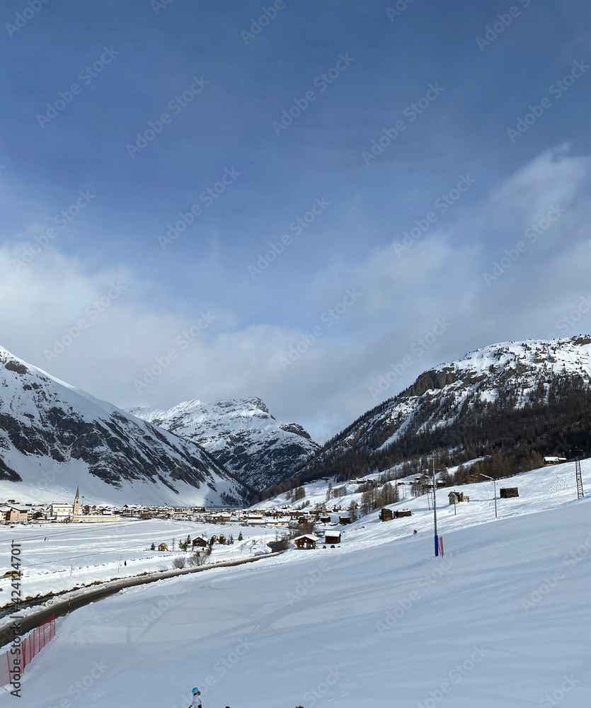 Winter weekend, sunny day. Ski resort. House in the mountains. Livigno, Italy