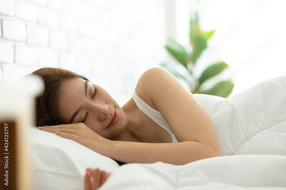 Asian women sleeping and sweet dream on white bed in bedroom Asian women sleeping and sweet dream on white bed in bedroom