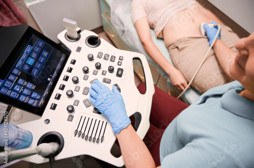 Female patient having ultrasound procedure in medical center.