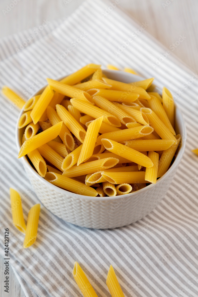 Uncooked Organic Penne Pasta in a Bowl, low angle view. Uncooked Organic Penne Pasta in a Bowl, low angle view.