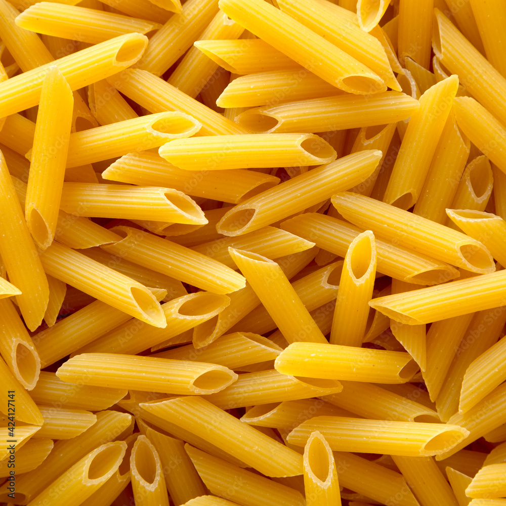 Uncooked Raw Organic Penne Pasta, overhead view. Uncooked Raw Organic Penne Pasta, overhead view.