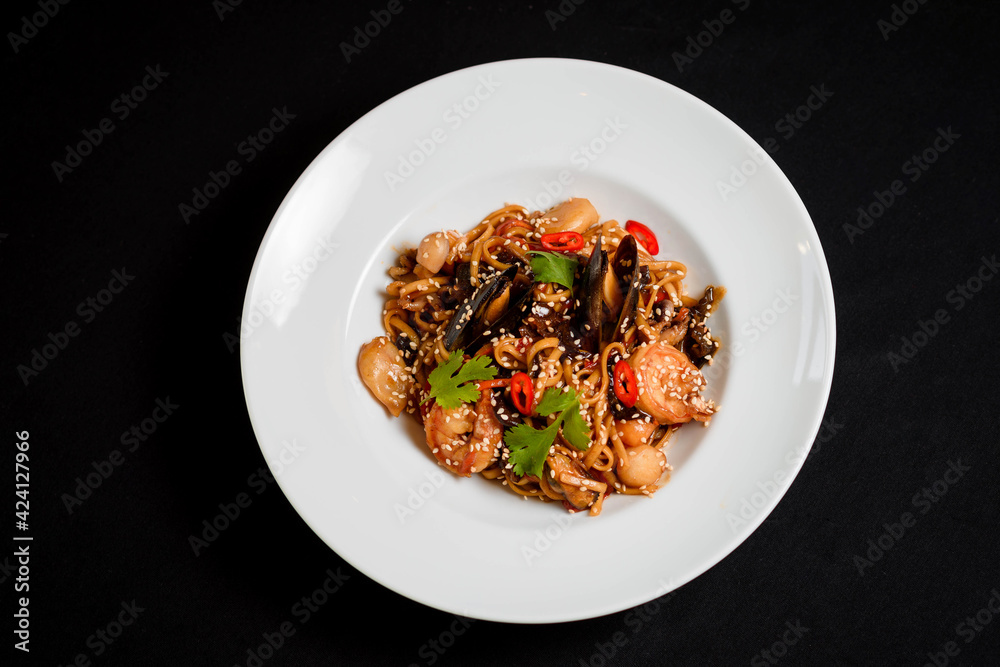 Decorated seafood pasta in a white plate