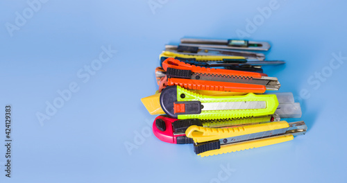 Several old paper cutters placed on a blue background. photo