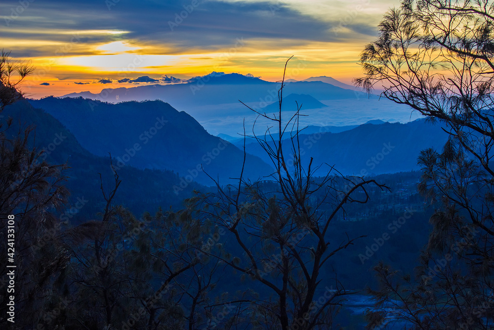Colorful golden sunrise near the erupting and active Bromo volcano. Bromo Tengger Semeru National Park, East Java, Indonesia. Colorful golden sunrise near the erupting and active Bromo volcano. Bromo Tengger Semeru National Park, East Java, Indonesia.