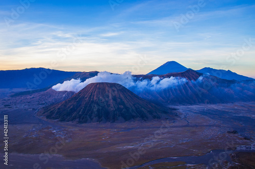 Terrific Bromo Tengger Semeru National Park on East Java, Indonesia. Aerial view of erupting volcano Bromo, Mount Semeru and Mount Batok from Penanjakan view point, observation area to see sunrise.