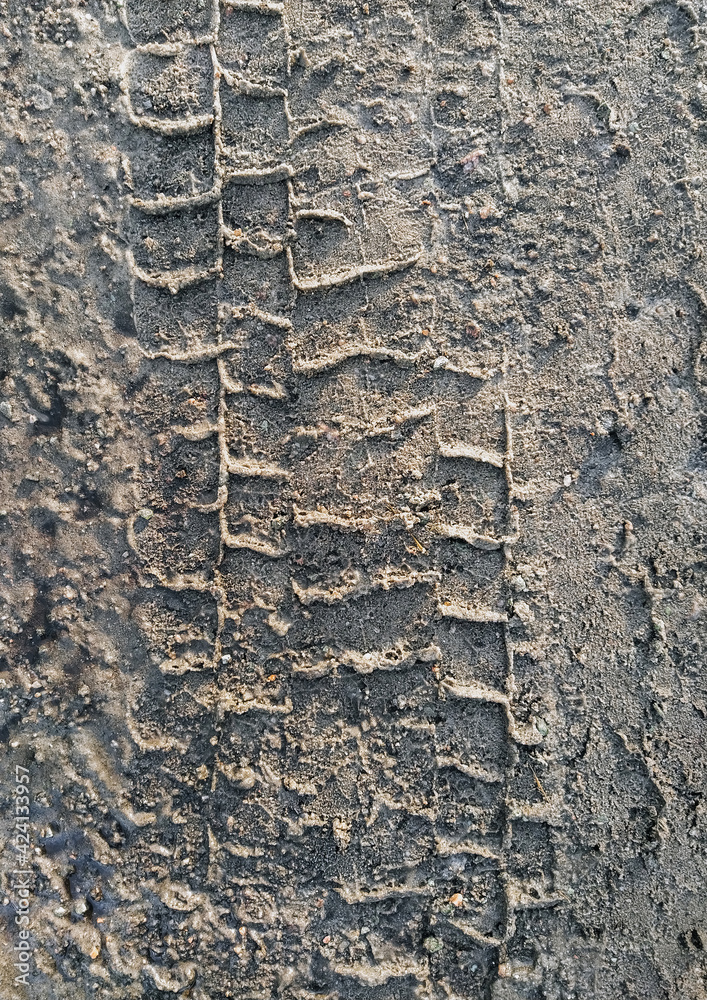 Textured traces, tread on dirty from the ground, sand, wet asphalt, from a truck. Bad, bumpy road. Photo background. Textured traces, tread on dirty from the ground, sand, wet asphalt, from a truck. Bad, bumpy road. Photo background.