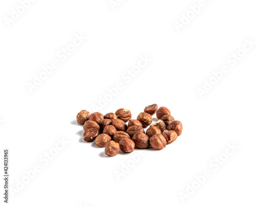 Hazelnuts without shell on a white background, isolated. Pile of hazelnut closeup. © Putnik_mira