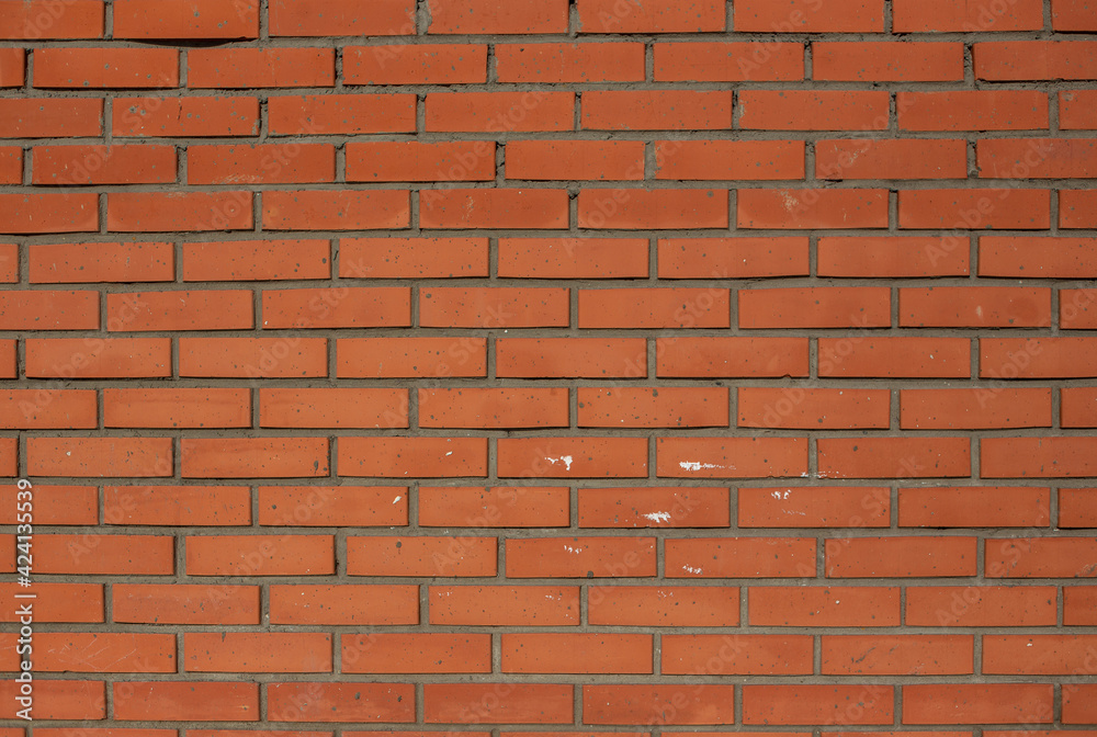 Fototapeta premium Red brick wall texture with dots and traces of white paint on it