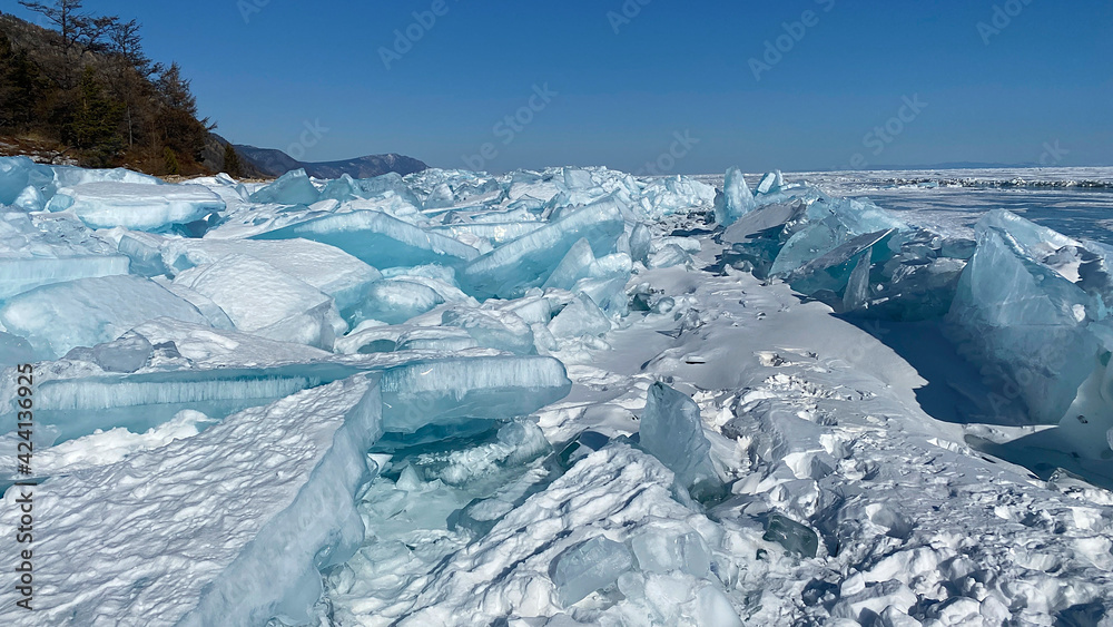 Fototapeta premium Ice hummocks of Lake Baikal covered with snow. Large, impenetrable chunks of ice.
