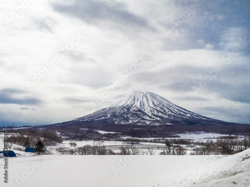 Snowy volcano and a field (Mount Yotei, Hokkaido, Japan)