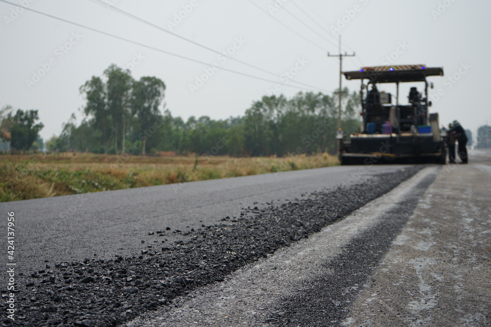 The image is blurred in the construction of asphalt road. The image is blurred in the construction of asphalt road.