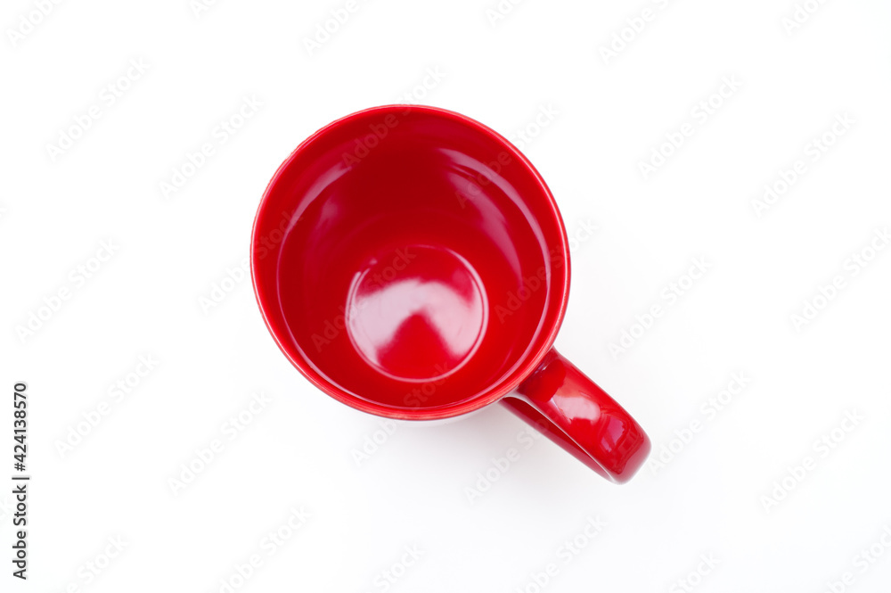 Red mug for tea or coffee on a white background. Top view Red mug for tea or coffee on a white background. Top view