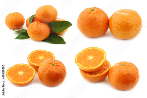 fresh tangerines, some leaves and a few cut ones on a white background