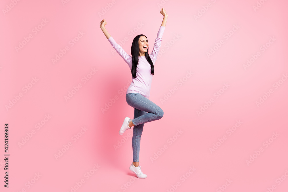 Fototapeta premium Full size photo of young beautiful excited cheerful positive crazy girl raise fists in victory isolated on pink color background