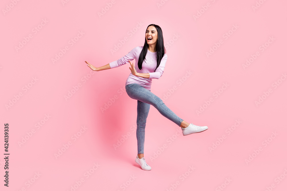 Full size photo of young beautiful attractive cheerful positive girl dancing look copyspace isolated on pink color background
