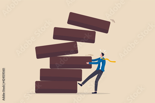 Investment risk, failure or mistake for greedy decision, business strategy to be careful and balance on instability and uncertainty concept, businessman pulling wooden block from collapsing stack.