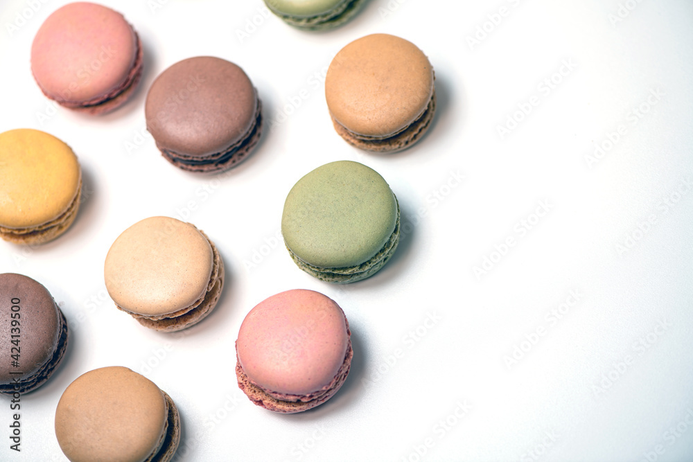 several multi-colored macaroon cakes on a white background several multi-colored macaroon cakes on a white background
