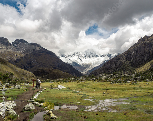 Panorama landscape of people hiking in mountain range in Huaraz, Peru 