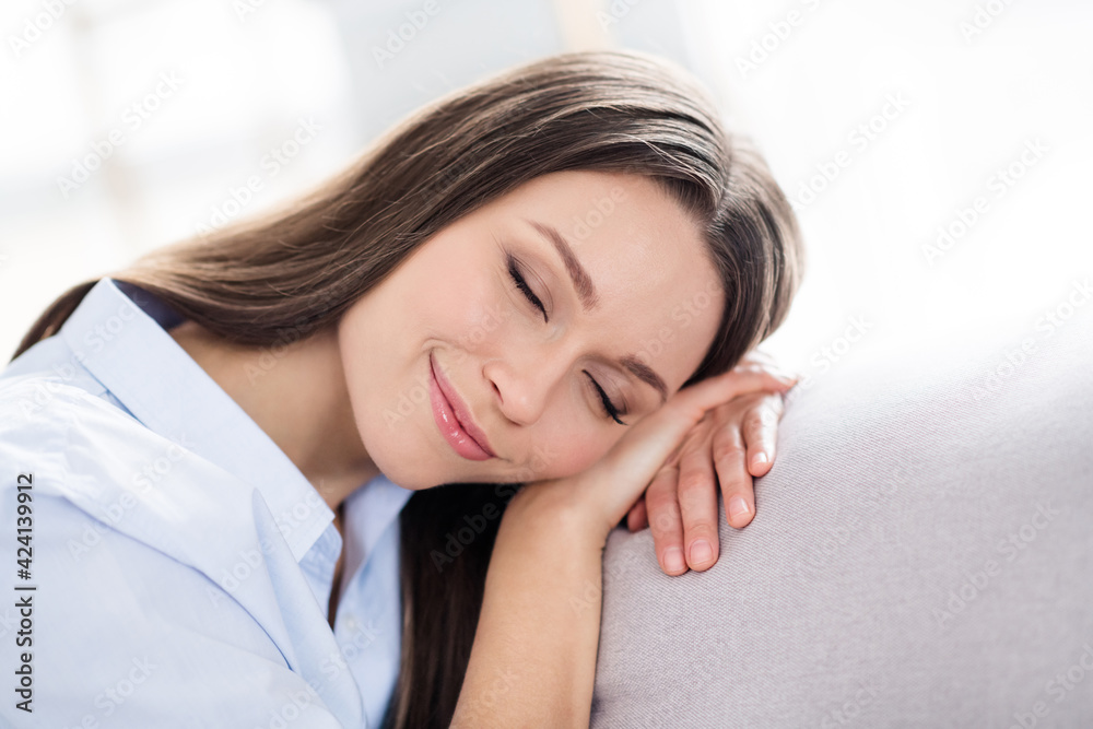Photo of nice optimistic brunette long hairdo lady lie on coach wear blue shirt alone at home Photo of nice optimistic brunette long hairdo lady lie on coach wear blue shirt alone at home