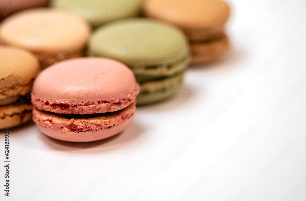 several multi-colored macaroon cakes on a white background several multi-colored macaroon cakes on a white background