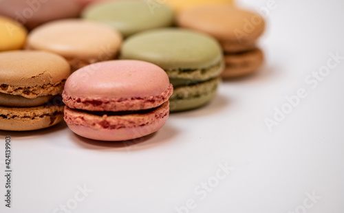 several multi-colored macaroon cakes on a white background