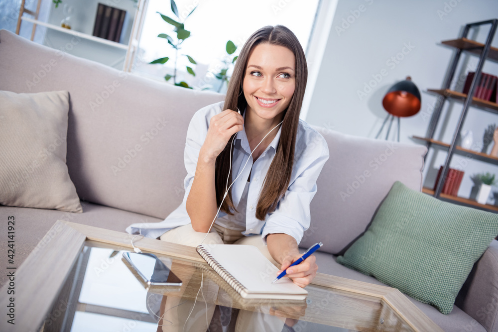 Photo of nice optimistic brunette lady sit with headphones write lookn wear shirt alone at home Photo of nice optimistic brunette lady sit with headphones write lookn wear shirt alone at home