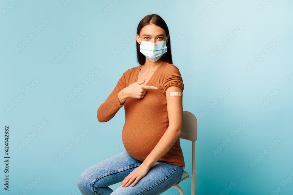 Vaccinated Pregnant Female Showing Arm After Getting Vaccine, Blue