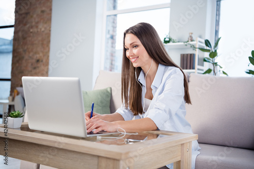 Photo of young beautiful charming smiling businesswoman sit sofa at home house remote working in laptop computer