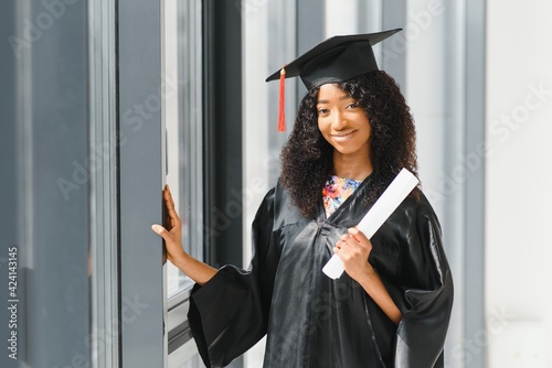 cheerful african american graduate student with diploma in her hand