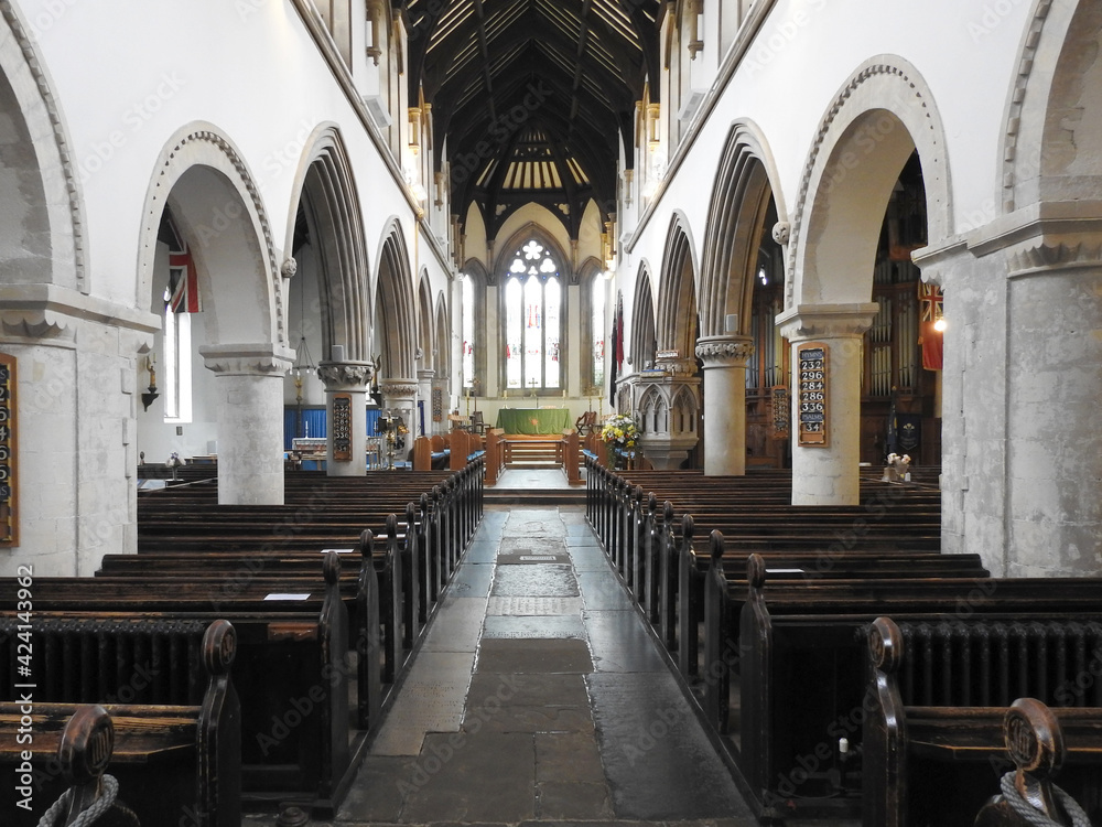 Long church interior with pews and columns