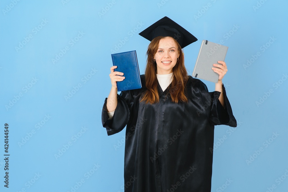 Beautiful woman wearing graduation cap and ceremony robe holding degree looking positive and happy standing and smiling with a confident smile. Beautiful woman wearing graduation cap and ceremony robe holding degree looking positive and happy standing and smiling with a confident smile.