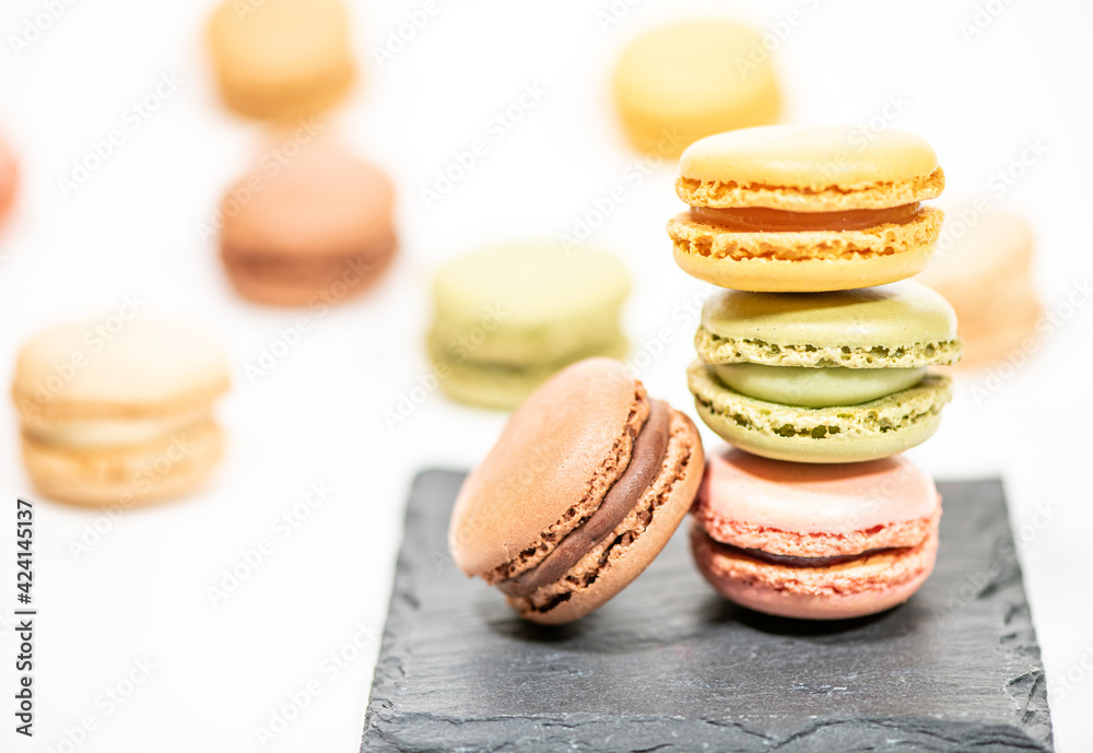 several multi-colored macaroon cakes on a white background several multi-colored macaroon cakes on a white background