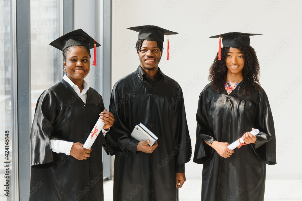 optimistic young university graduates at graduation optimistic young university graduates at graduation