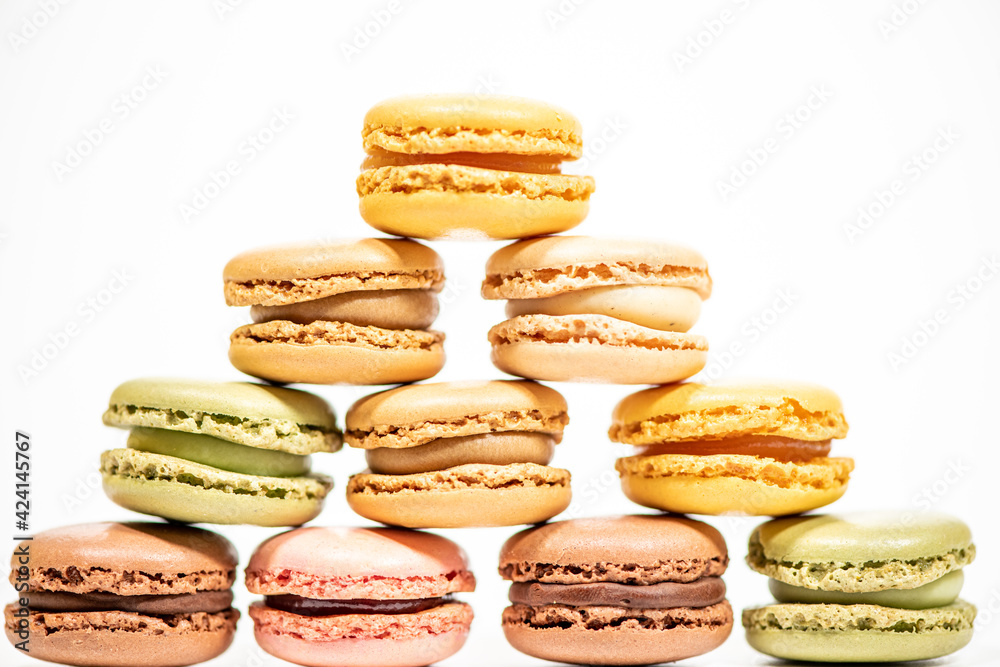 several multi-colored macaroon cakes on a white background