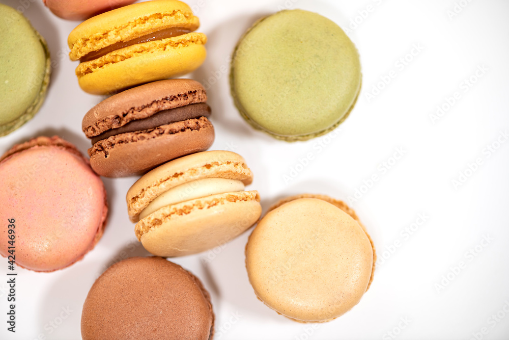 several multi-colored macaroon cakes on a white background several multi-colored macaroon cakes on a white background