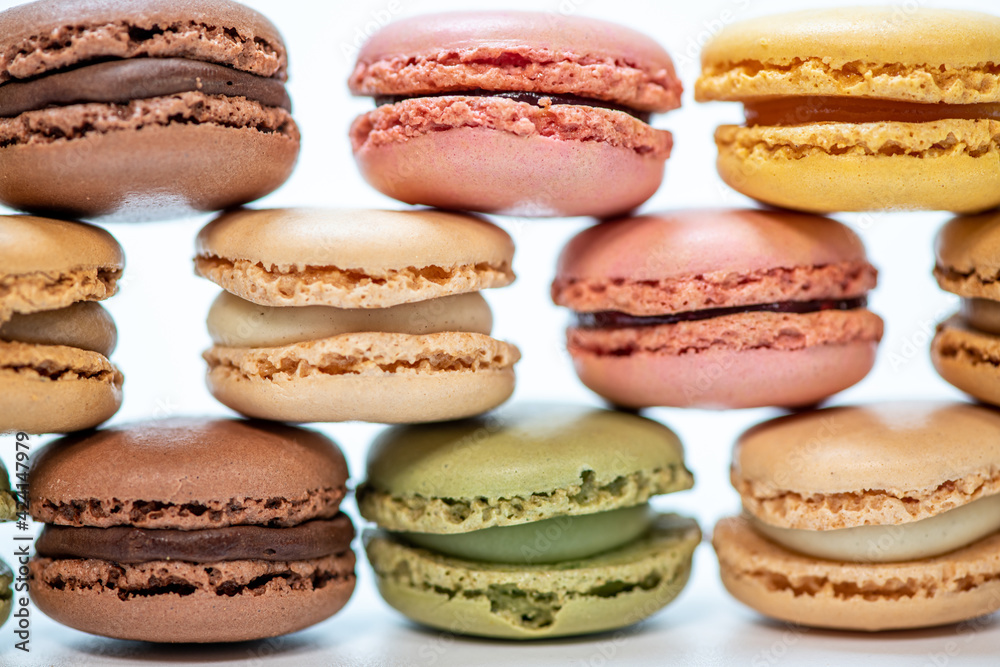 several multi-colored macaroon cakes on a white background several multi-colored macaroon cakes on a white background