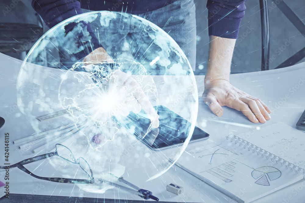 Double exposure of man's hands holding and using a phone and international business theme drawing. Double exposure of man's hands holding and using a phone and international business theme drawing.